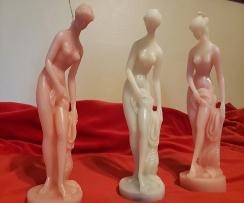 Three naked ladies representing our elegant candles collection.