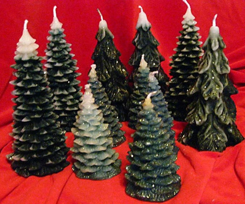 Assorted Christmas trees representing our seasonal candles collection.